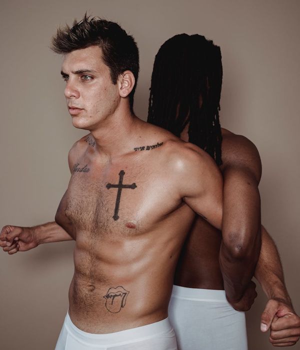 Man performing a strength exercise in a modern gym setting.